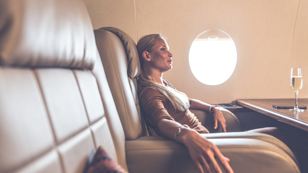 lady in a reclining chair inside a private jet
